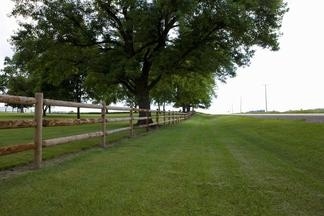 Wood fence surrounding a huge ranch in Baton Rouge. Fence sits a few yards from highway.